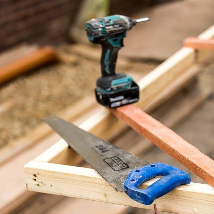 Saw And Drill On Wooden Frame
