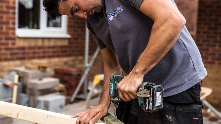 Carpenter Working On Wooden Frame